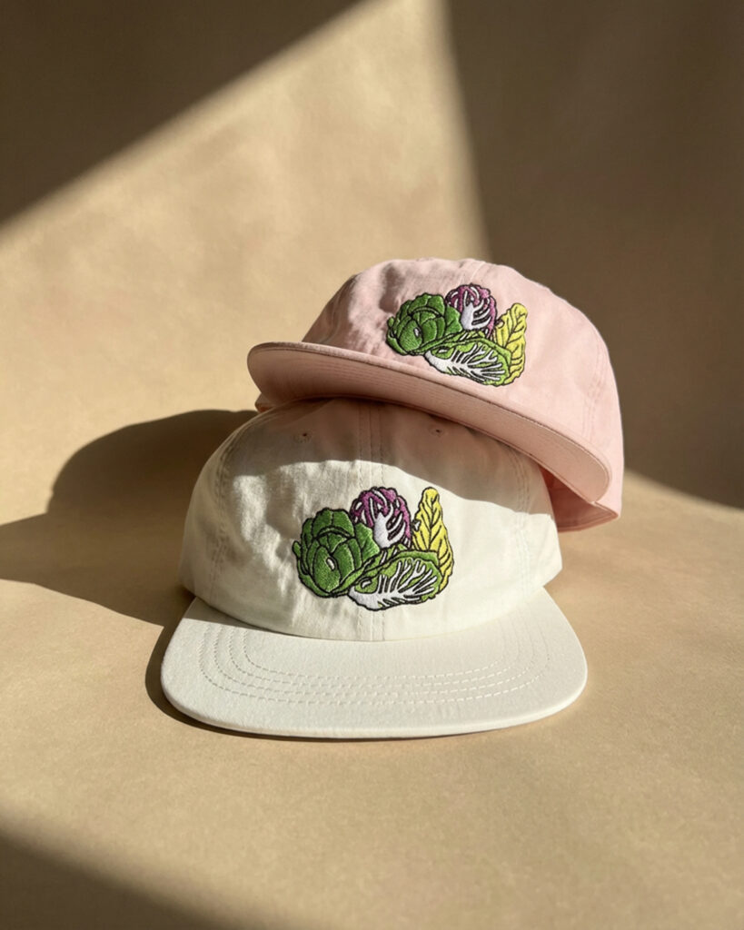Pink and white embroidered caps stacked